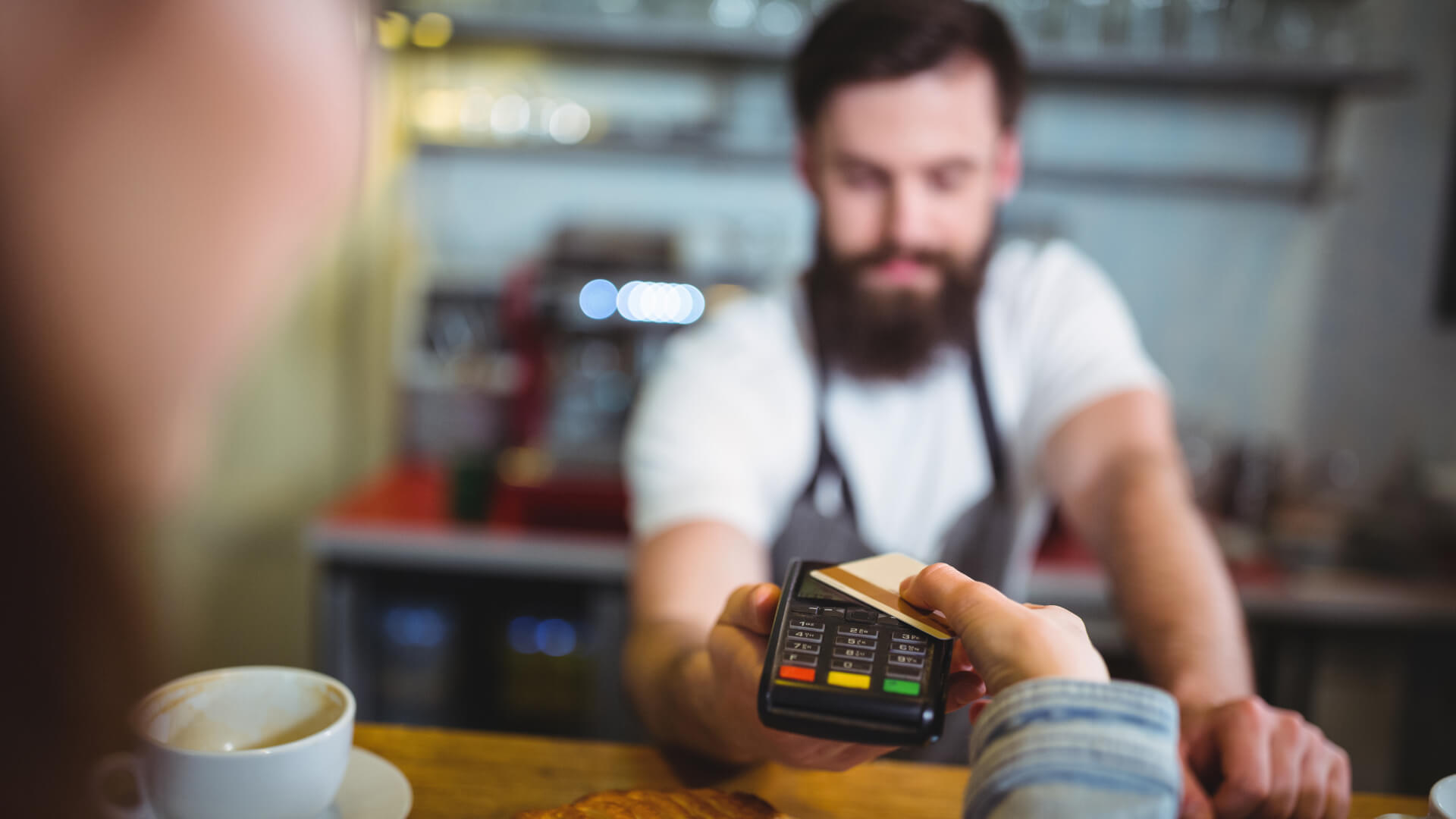 customer-making-payment-through-payment-terminal-counter